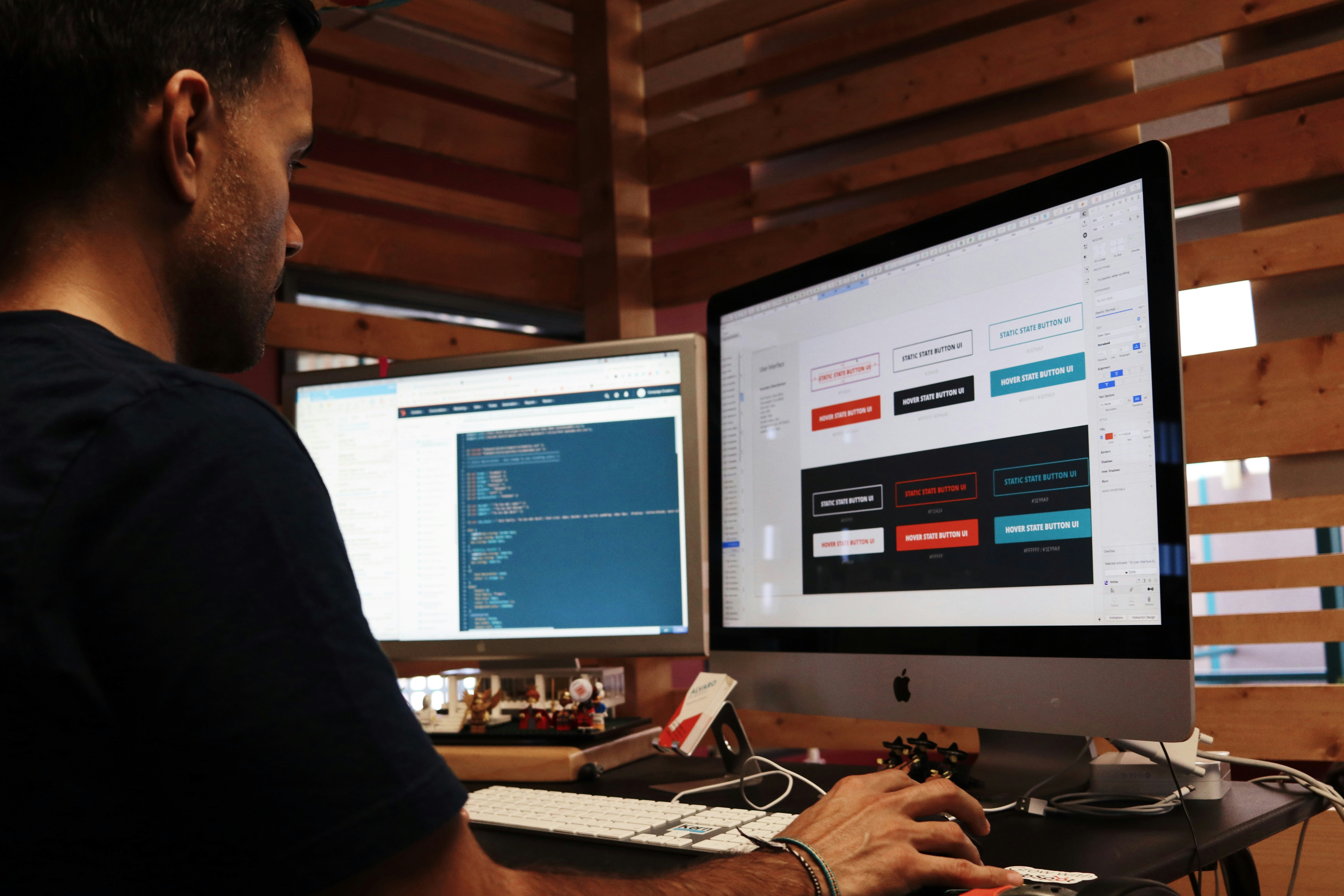 Web developer working on multiple screens with design interface