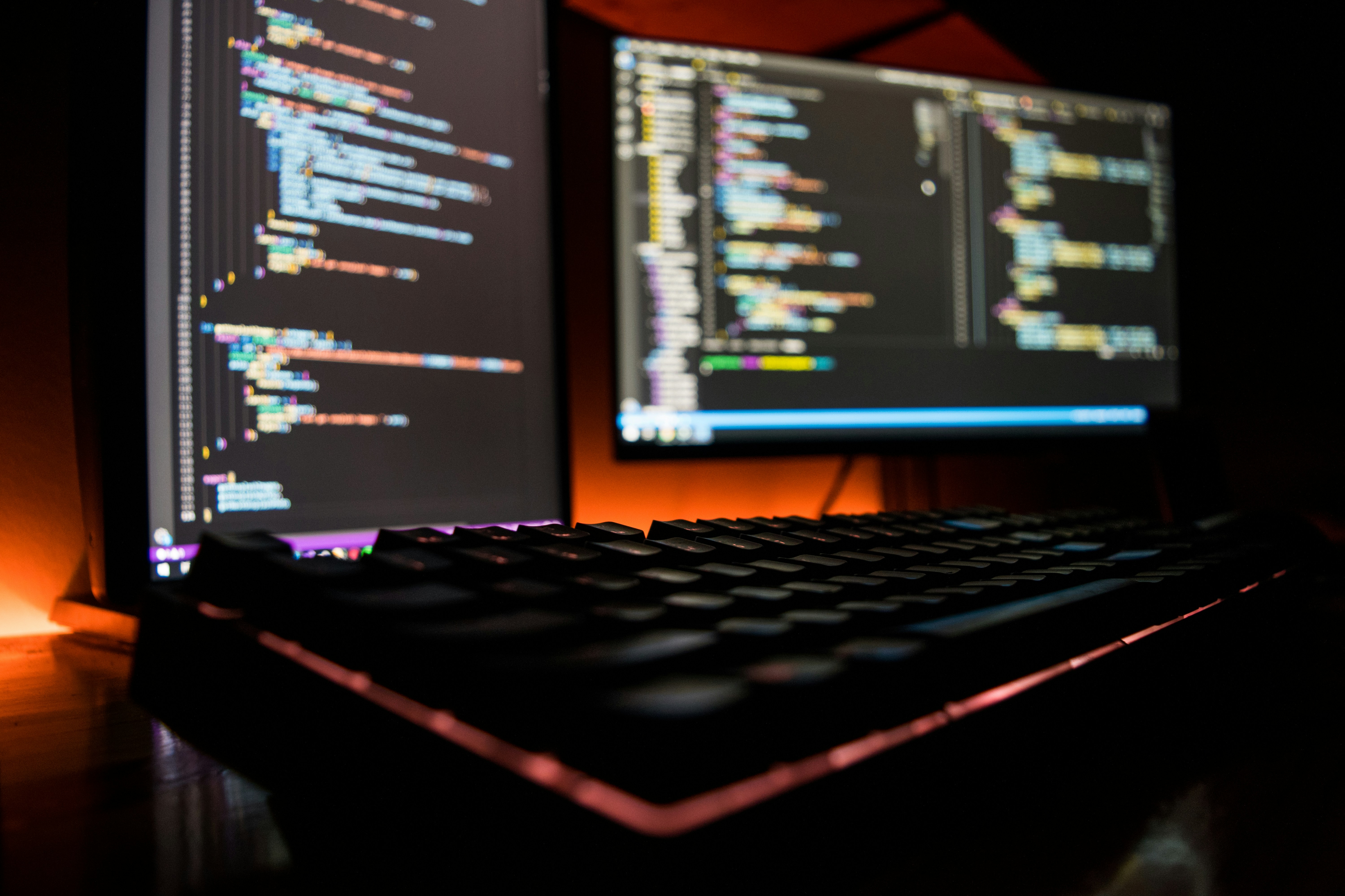 Developer workspace with multiple monitors showing code