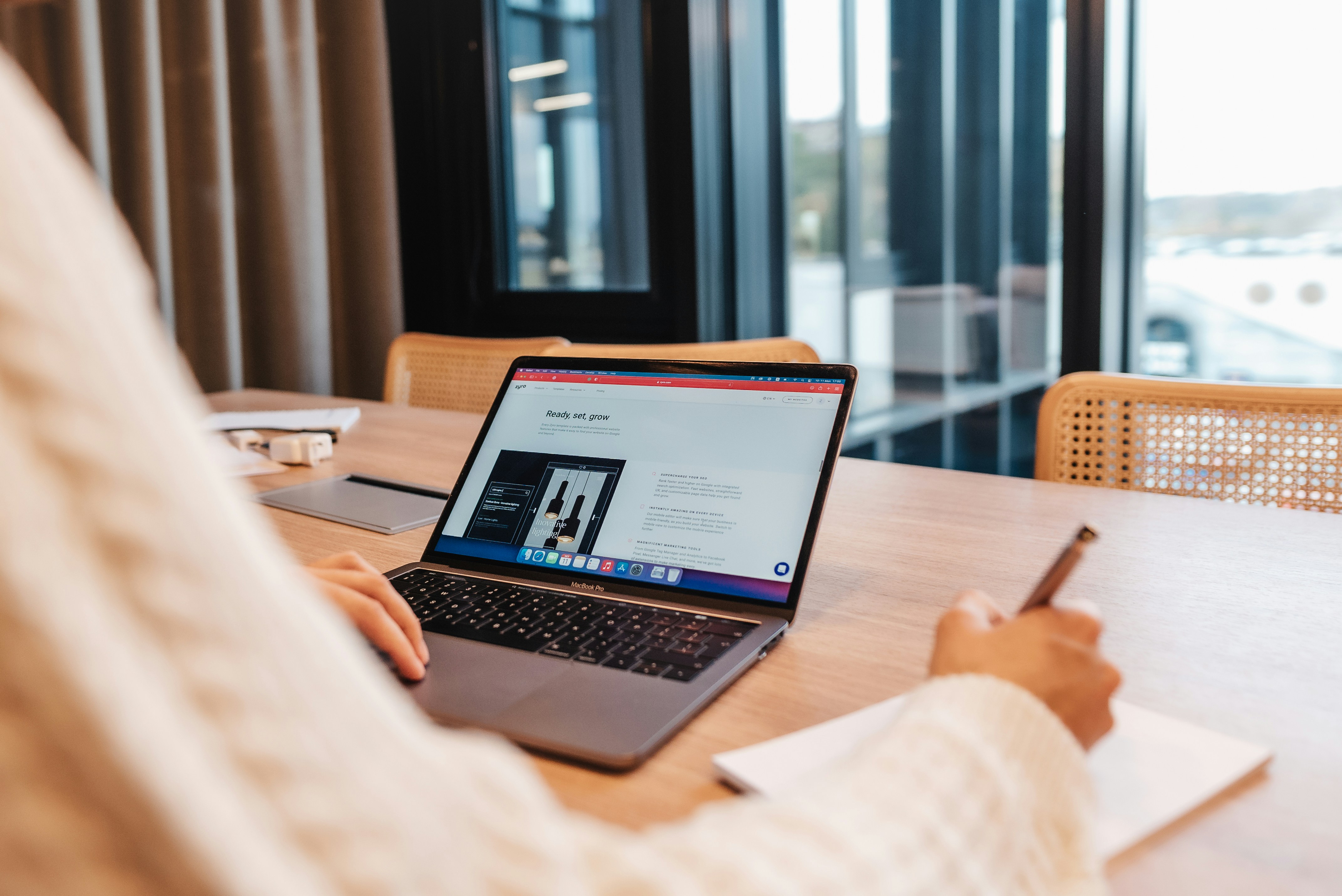 Professional working on laptop in modern office